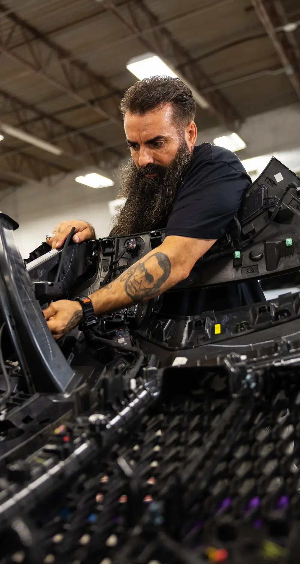 Chris Joerger hand-fitting a disassembled dash assembly at Big Shot Rides