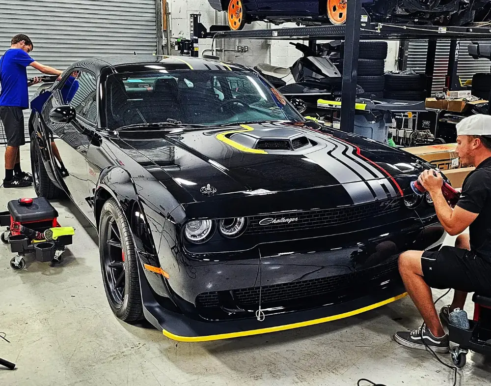 Machine paint correction in progress on a Dodge Challenger at Big Shot Rides