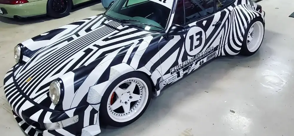Custom dazzle livery wrap designed and installed by Big Shot Rides on a widebody Porsche 911