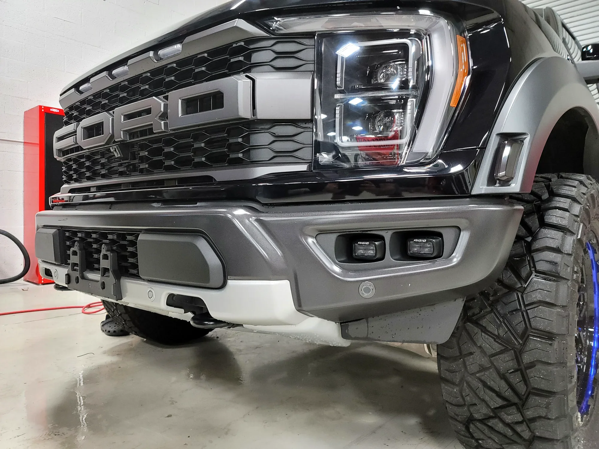 AMP Research PowerStep electric running boards installed on a Ford Raptor at Big Shot Rides
