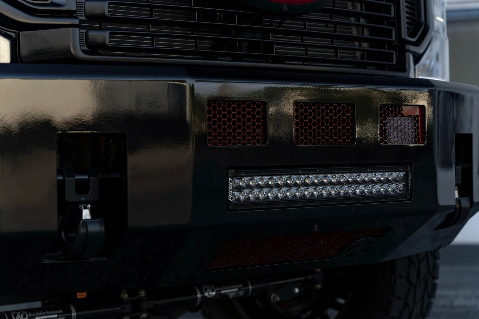 Rigid bumper pod light detail on a black Super Duty, Big Shot Rides Broward County