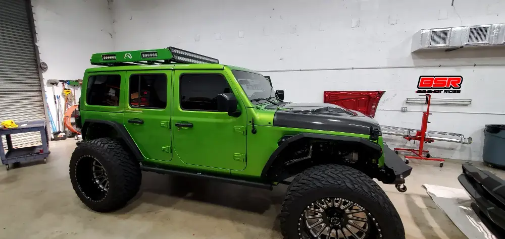 Lifted Jeep Wrangler with Fab Fours roof rack and dual LED light bars installed at Big Shot Rides, Coconut Creek FL