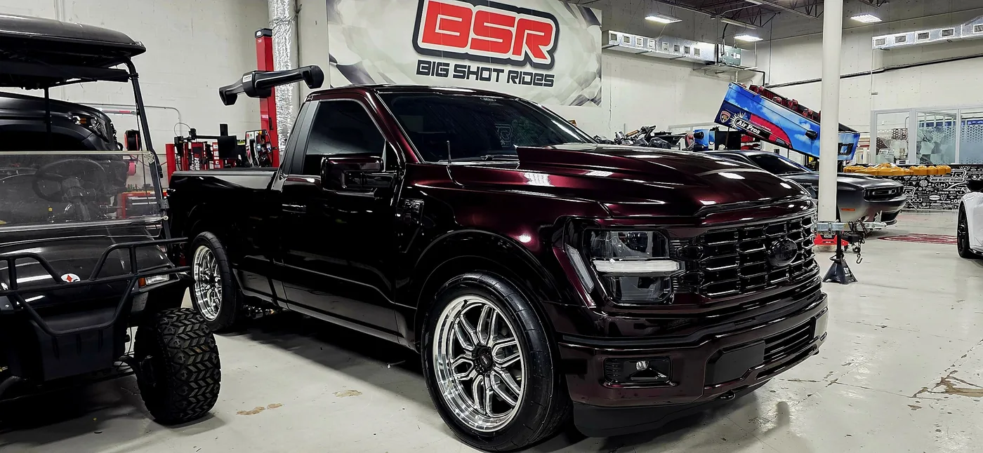 Maroon Ford F-150 lowered on custom wheels at Big Shot Rides