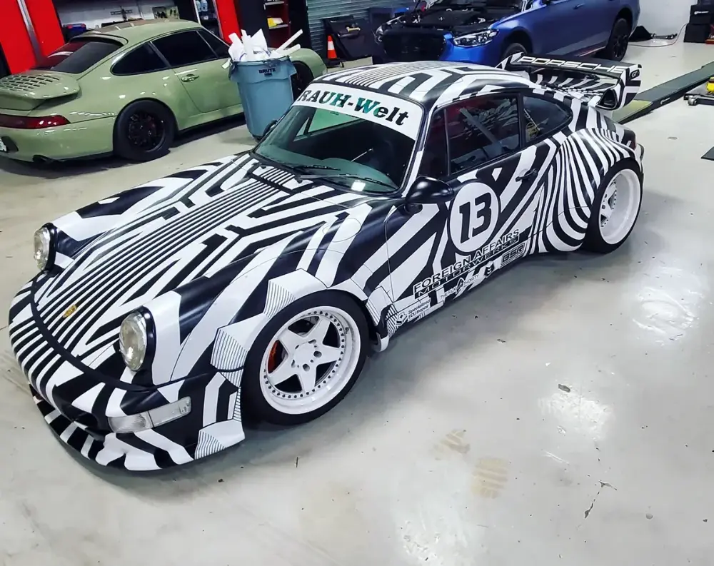 Custom black and white geometric livery wrap on widebody Porsche 911 by Big Shot Rides