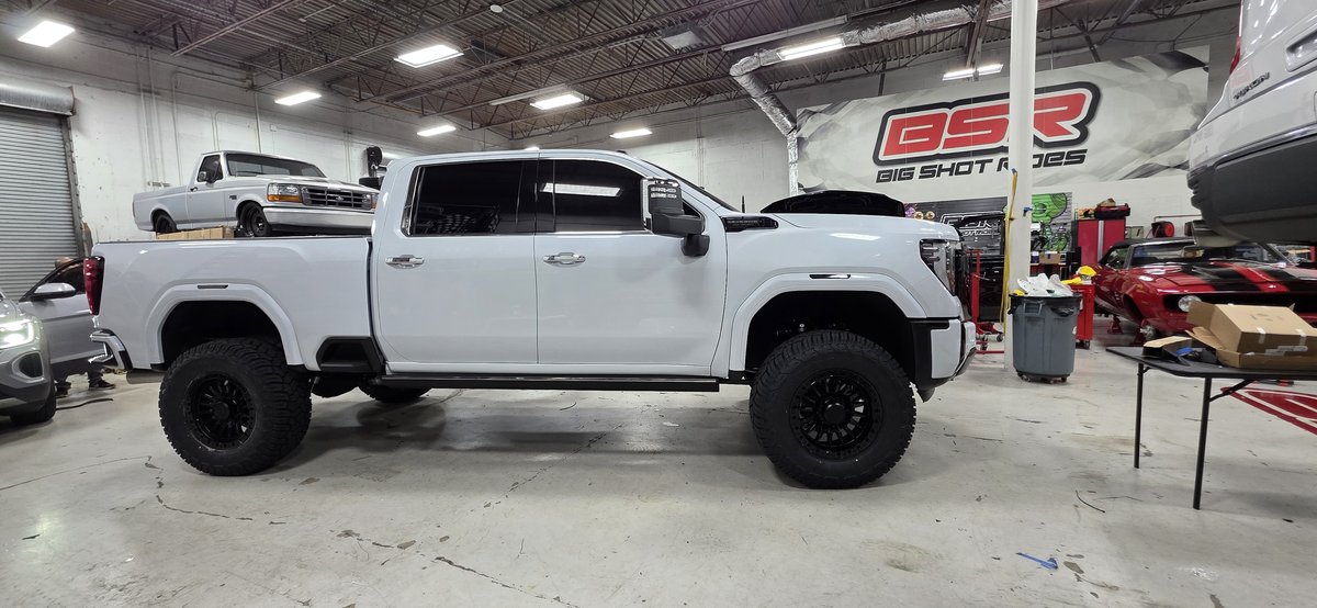 Lifted white GMC Sierra Denali HD at Big Shot Rides shop in Coconut Creek FL