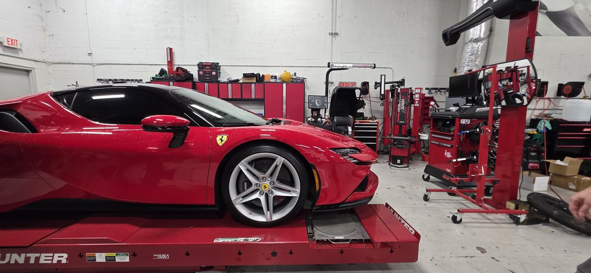 Wide view of the Big Shot Rides shop in Coconut Creek FL with Hunter alignment rack and Ferrari SF90