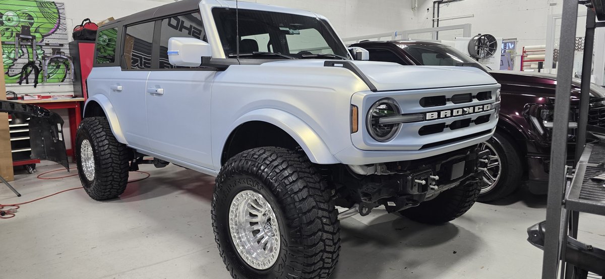 White matte Ford Bronco lifted with mud-terrain tires at Big Shot Rides