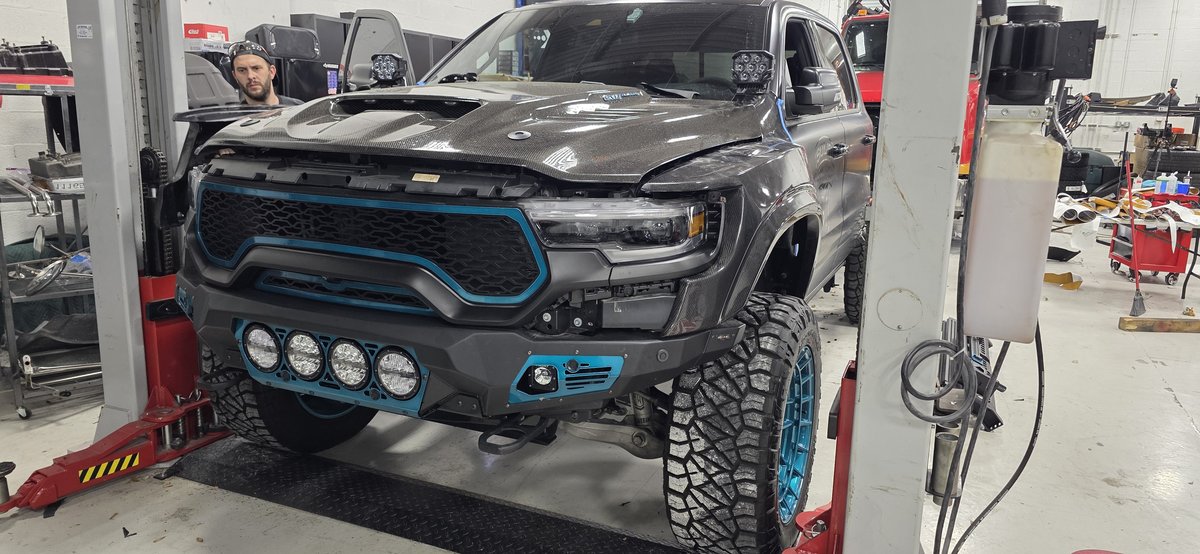 Custom RAM TRX with teal front bumper and integrated light pods at Big Shot Rides Coconut Creek