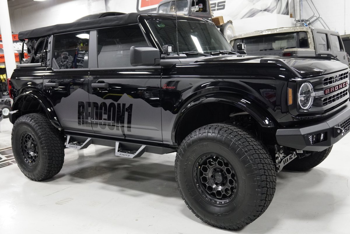 Black REDCON1 wrapped Ford Bronco with running boards and custom bumper at Big Shot Rides