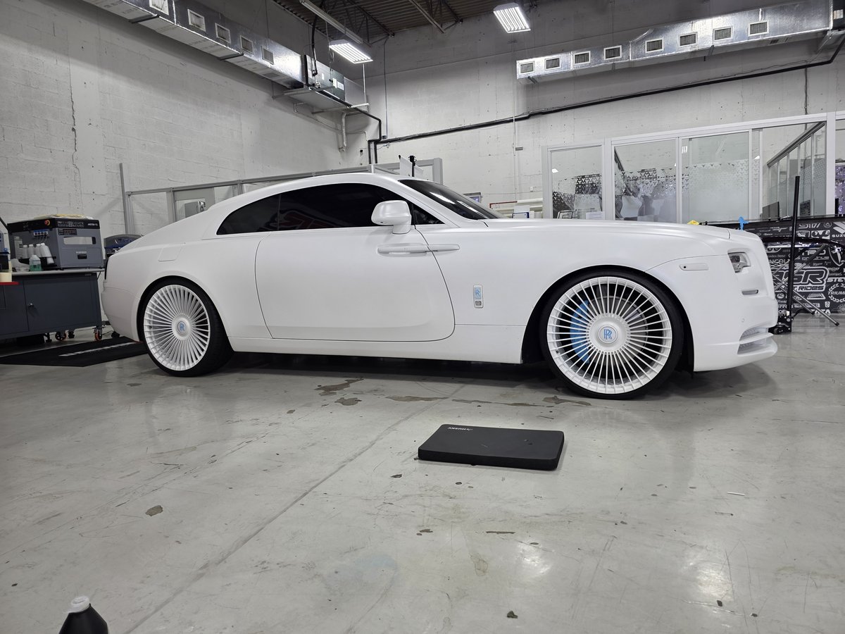 White Rolls-Royce Wraith on custom wheels at Big Shot Rides Coconut Creek detail bay