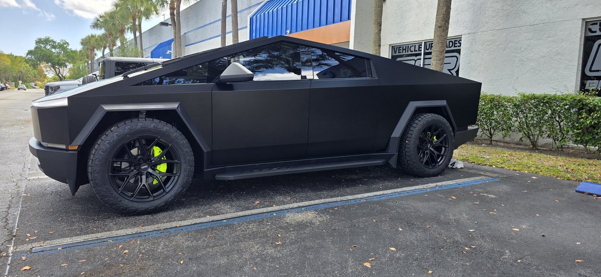 Matte black Tesla Cybertruck with all-terrain tires at Big Shot Rides Coconut Creek FL