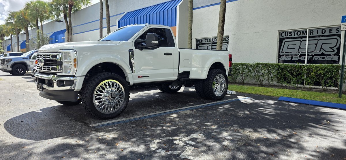 White Ford F-350 Super Duty dually with custom chrome wheels and tires at Big Shot Rides Coconut Creek