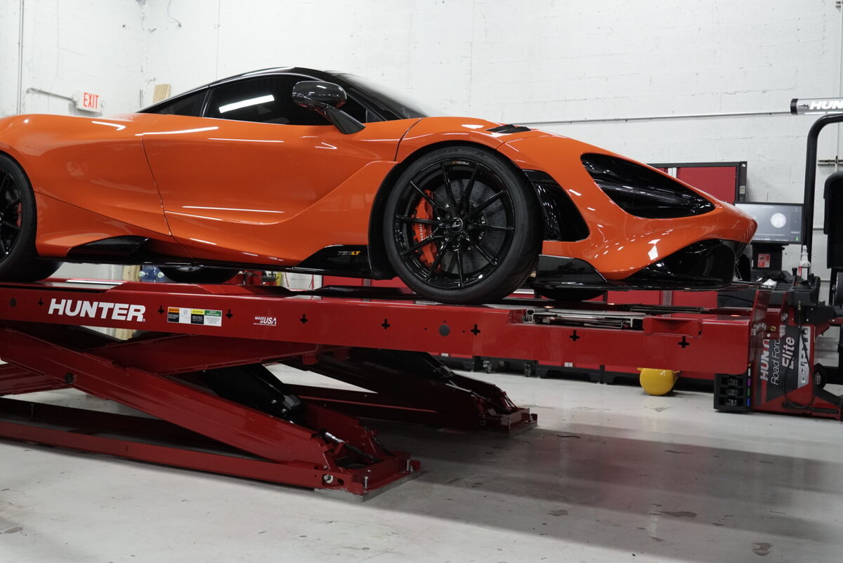 Orange McLaren 765LT on Hunter alignment rack at Big Shot Rides Coconut Creek FL