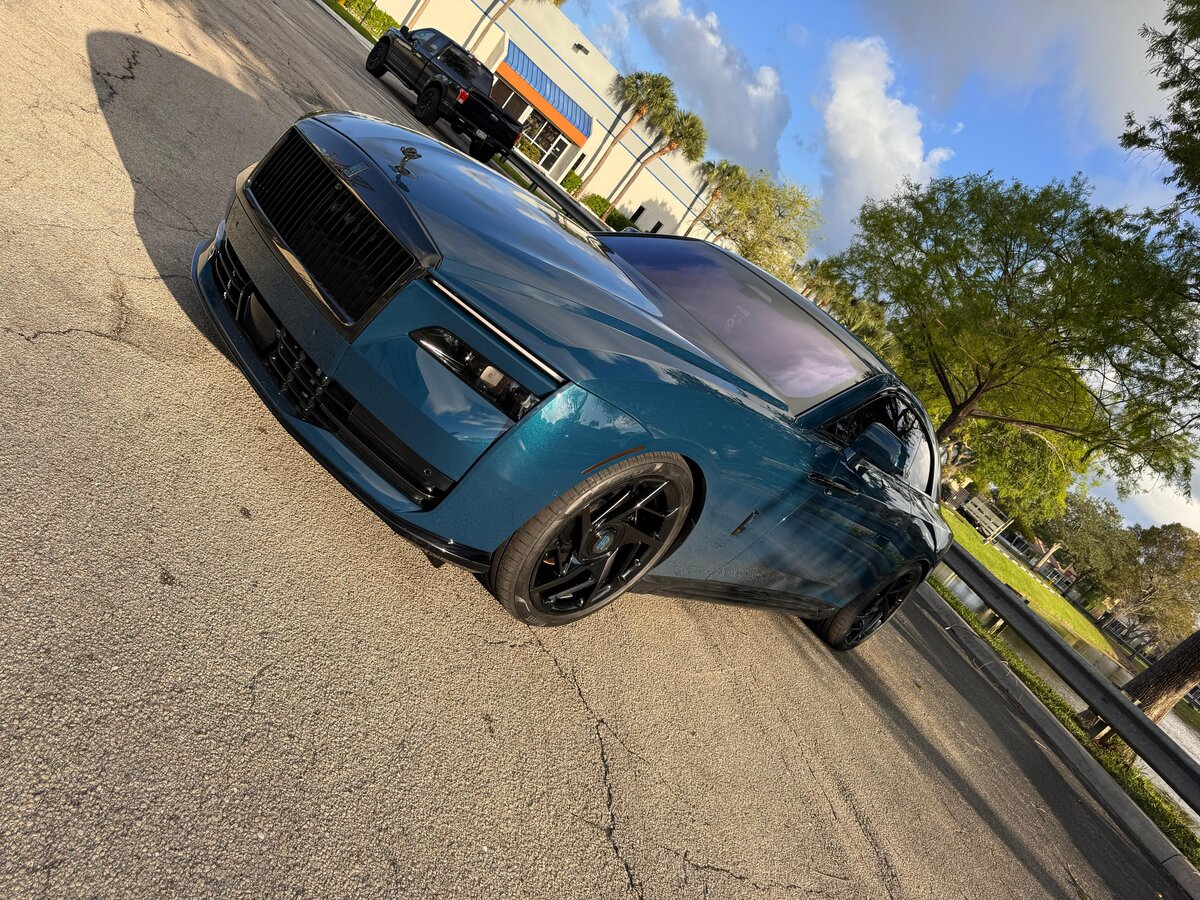 Teal Rolls-Royce Spectre chrome delete