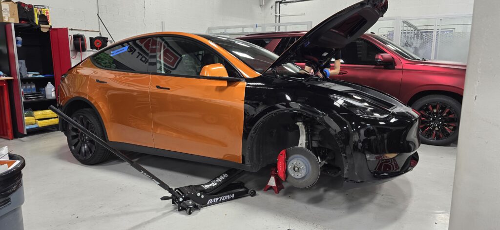 Tesla Model Y in a custom orange and black vinyl wrap by Big Shot Rides, Coconut Creek, Florida