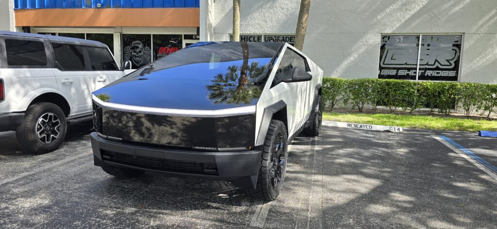 Tesla Cybertruck wrapped in 3M high gloss black with high gloss white sides at Big Shot Rides in Coconut Creek, Florida