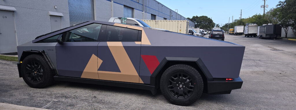 Tesla Cybertruck in a matte commercial wrap with geometric graphics for Sunshine Alliance Cabinetry, installed by Big Shot Rides in Coconut Creek, Florida